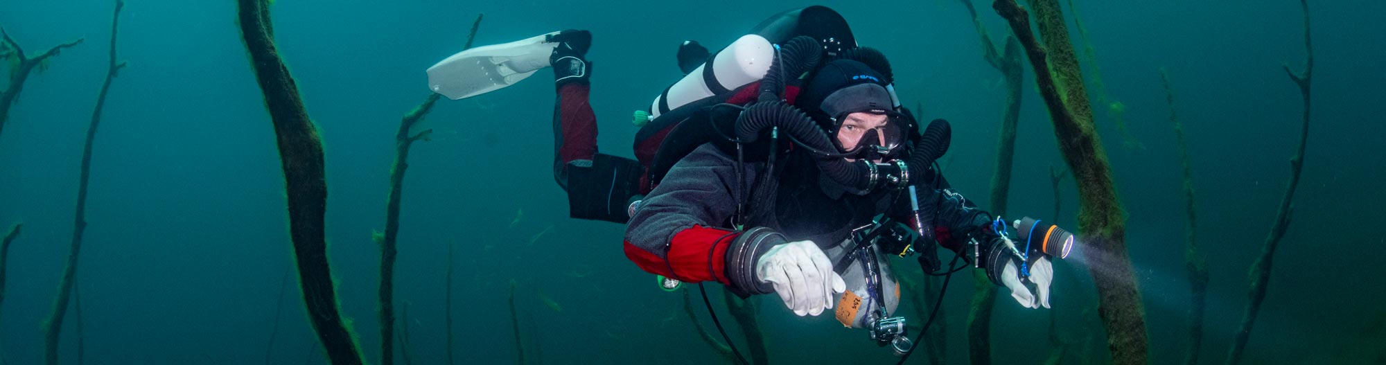 Diver in a lake wearing a Prism 2 Rebreather