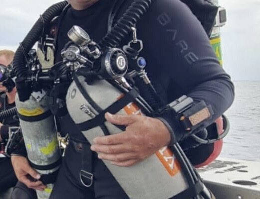 Jason Cunningham wearing a Prism 2 Rebreather on a boat