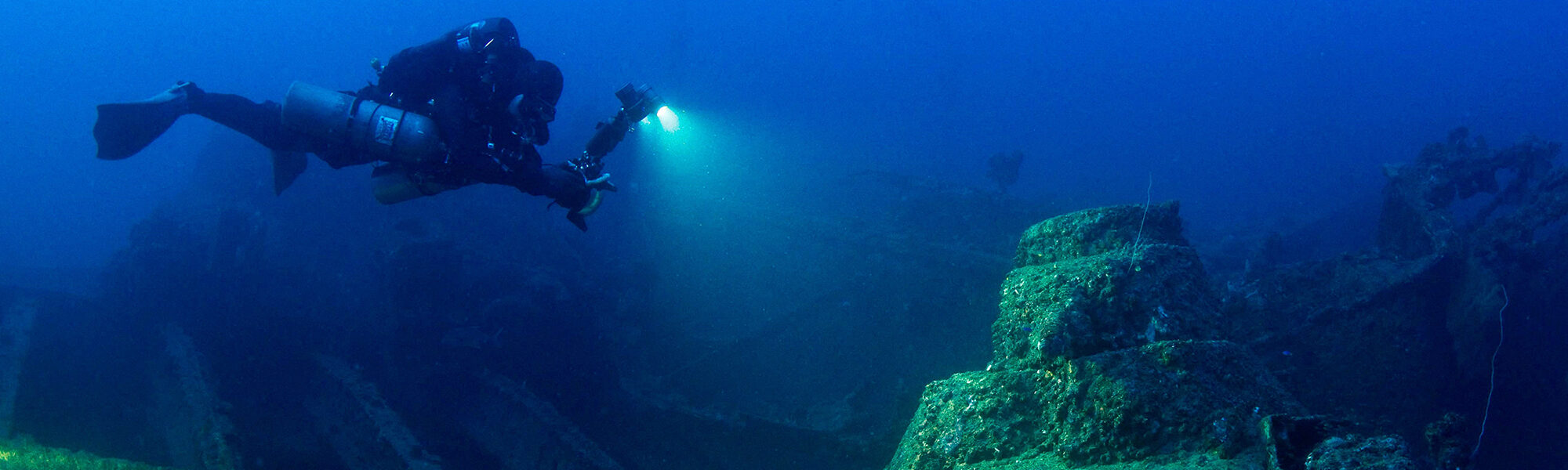 scuba diver wearing a Prism 2 Rebreather at night